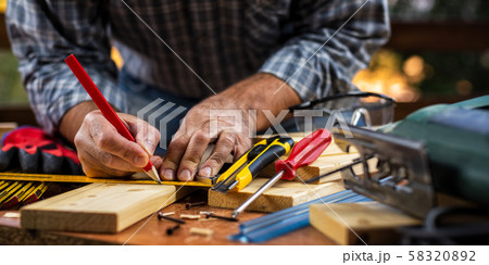 Craftsman at work on wooden boards. Carpentry. 58320892