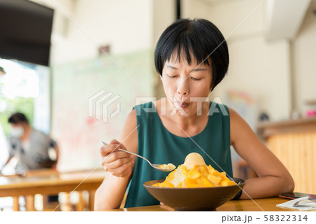 woman eat mango shave ice 58322314
