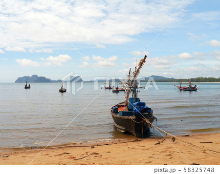 Fishing boats moored along the beach 58325748