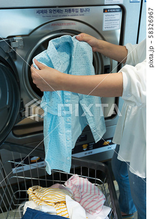 Single life concept, washing machines at laundromat 143 58326967
