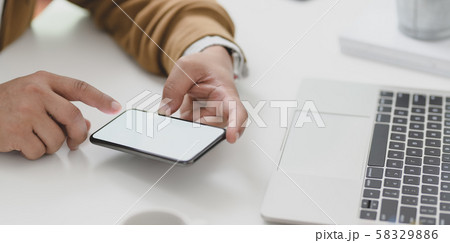 Young businessman looking at information in blank Young businessman looking at information in blank 58329886