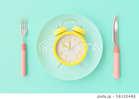 Yellow clock on the blue-green plate 58330488