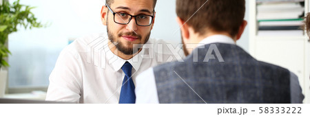 Two smiling clerk businessmen deliberate on problem Two smiling clerk businessmen deliberate on problem 58333222
