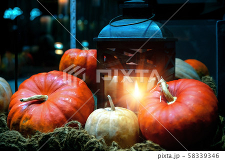 Old lantern with burning candle, pumpkins and Old lantern with burning candle, pumpkins and 58339346