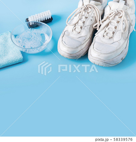 Dirty white sneakers withspecial cleaning tools 58339576