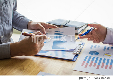 Business people meeting point to discuss, plan and chart the rise and fall of economic on white background. 58340236