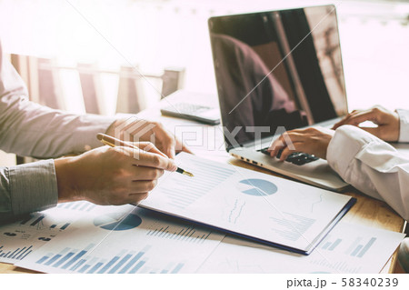 Business people meeting point to discuss, plan and chart the rise and fall of economic. 58340239