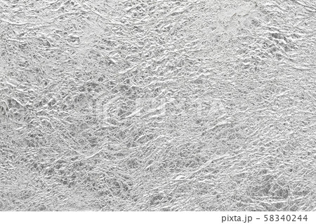 Silver paper crumpled mess glossy shiny texture background. 58340244