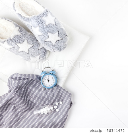 Soft fluffy slippers and blue alarm clock Soft fluffy slippers and blue alarm clock 58341472
