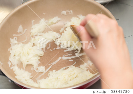 玉ねぎを炒める女性 58345780