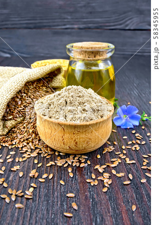 Flour linen in bowl with flower and oil Flour linen in bowl with flower and oil 58345955