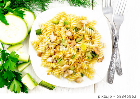 Fusilli with chicken and zucchini in plate Fusilli with chicken and zucchini in plate 58345962