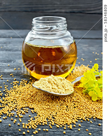 Mustard powder in spoon with oil on board Mustard powder in spoon with oil on board 58346809