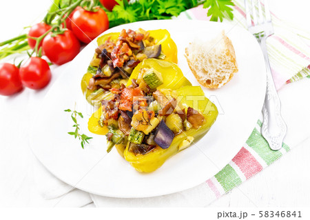 Pepper stuffed with vegetables in plate on board Pepper stuffed with vegetables in plate on board 58346841