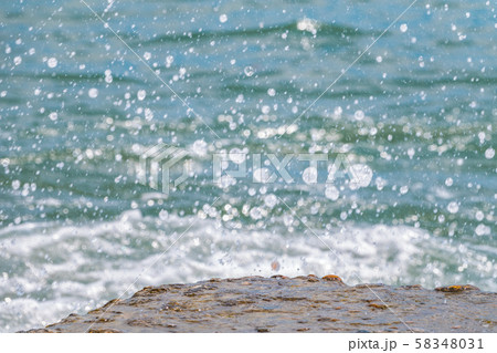 Splashes and drops of water on a blue sea Splashes and drops of water on a blue sea 58348031