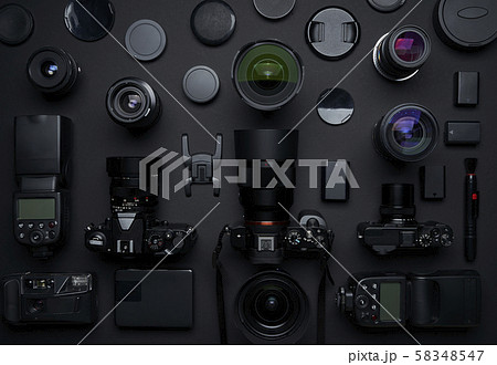 Flat lay top view of many various unknown brand camera,lens and photography equipment on black background . Flat lay top view of many various unknown brand camera,lens and photography equipment on black background . 58348547