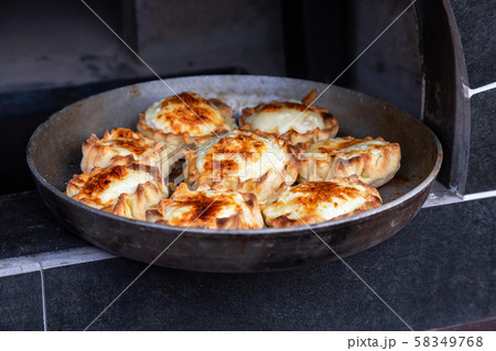 Cooking delicious pies in a Russian oven Cooking delicious pies in a Russian oven 58349768