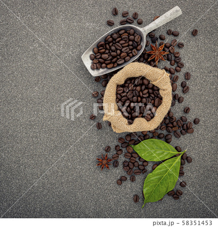 Dark roasted coffee beans on stone background. Top 58351453