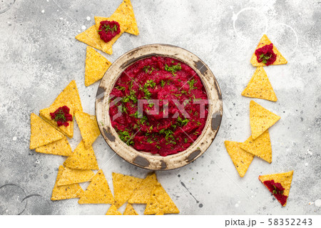 Beetroot hummus in a bowl on gray board Beetroot hummus in a bowl on gray board 58352243
