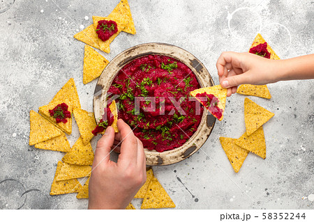 Beetroot hummus in a bowl on gray board Beetroot hummus in a bowl on gray board 58352244