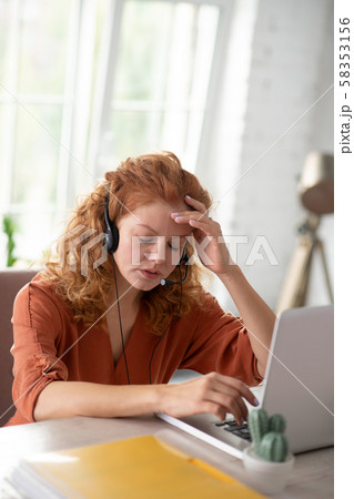 Freelancer sitting in front of computer having strong headache Freelancer sitting in front of computer having strong headache 58353156