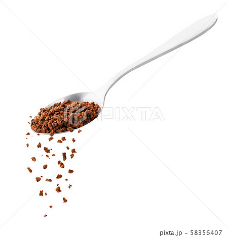 Instant coffee spills from a spoon on a white Instant coffee spills from a spoon on a white 58356407