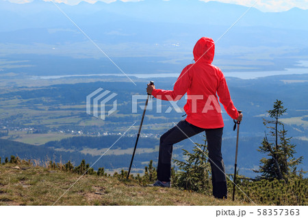 Girl tourist on top of the mountain. Girl tourist on top of the mountain. 58357363