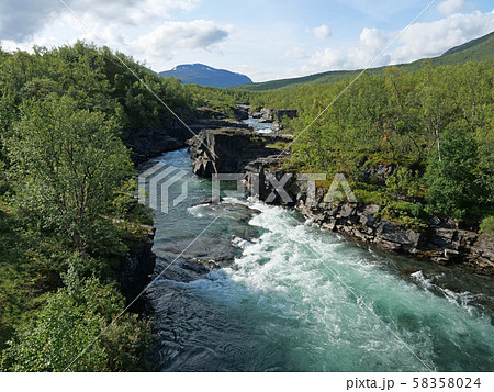 Lapland nature landscape. Abisko blue river canyon carved in the limestone and granite by glacial Lapland nature landscape. Abisko blue river canyon carved in the limestone and granite by glacial 58358024