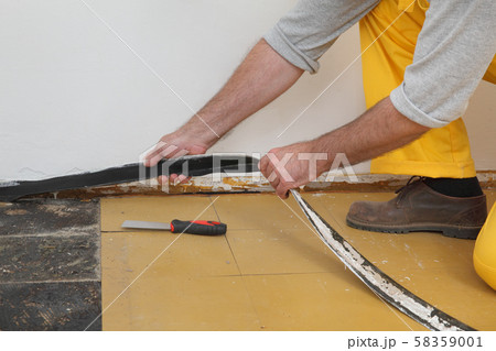 Old vinyl tiles removal from floor in a room or 58359001