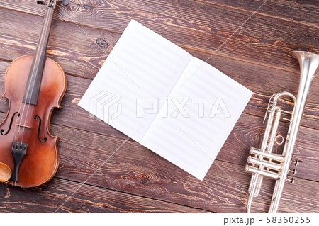 Old violin, trumpet and musical notes. 58360255