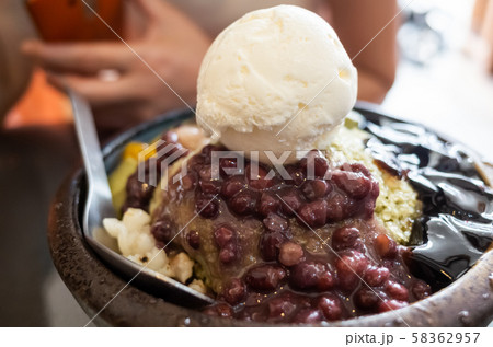 eating shaved ice with colorful dessert 58362957