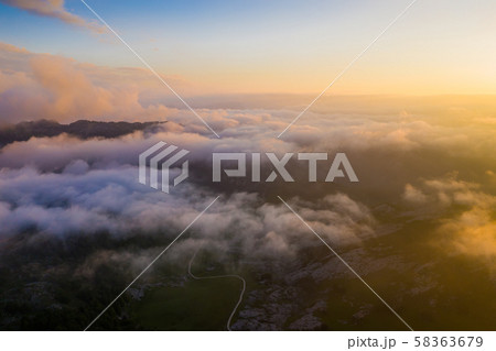Picos de Europa in clouds during sundown Picos de Europa in clouds during sundown 58363679