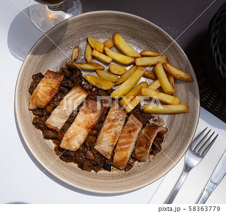 Iberian pork in sweet wine with stewed vegetables. Spanish dish 58363779