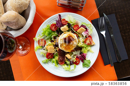 Salad from goat cheese with lettuce, meat, tomatoes and honey Salad from goat cheese with lettuce, meat, tomatoes and honey 58363856