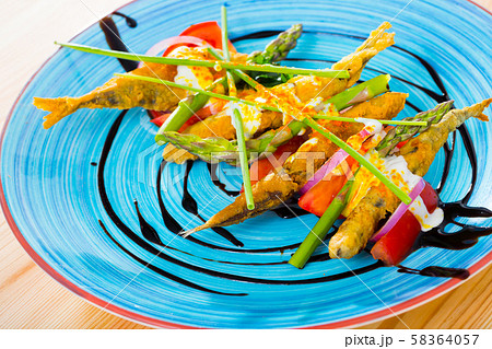 Battered sprats with creamy ginger sauce, tomatoes, balsamic 58364057