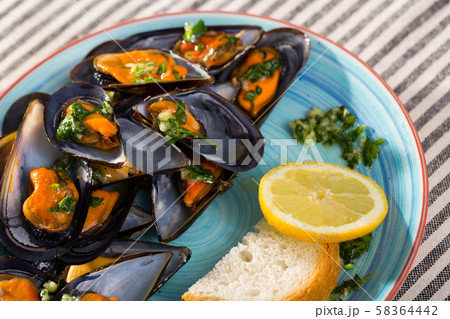Mussels with lemon sauce is tasty dish Mussels with lemon sauce is tasty dish 58364442