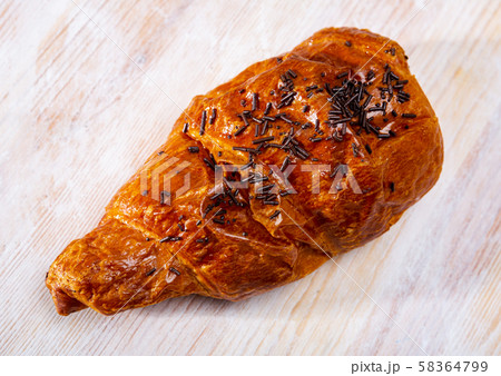 Chocolate snail croissant, french dessert at wooden surface Chocolate snail croissant, french dessert at wooden surface 58364799