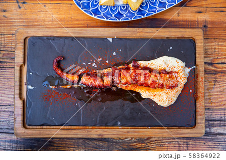 Ggrilled octopus tentacle with potato parmentier 58364922