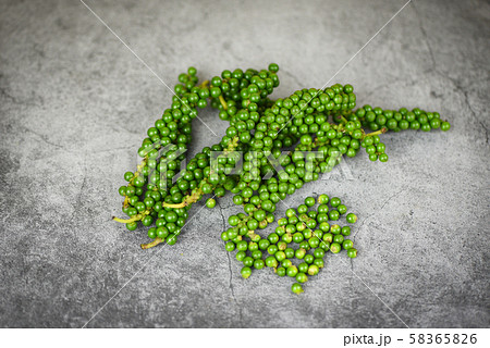 peppercorns on plate background - fresh green peppercorns on plate background - fresh green 58365826