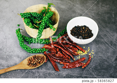 peppercorns on basket and dried chilli on dark peppercorns on basket and dried chilli on dark 58365827