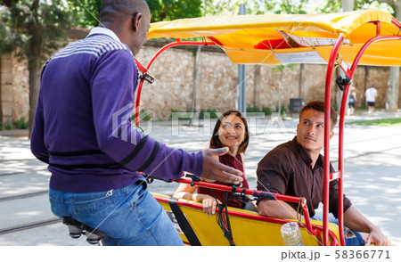 Active girl with boyfriend traveling on rickshaw Active girl with boyfriend traveling on rickshaw 58366771