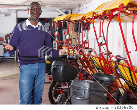 African-American man pedicab driver offering cycle rickshaw service 58366800