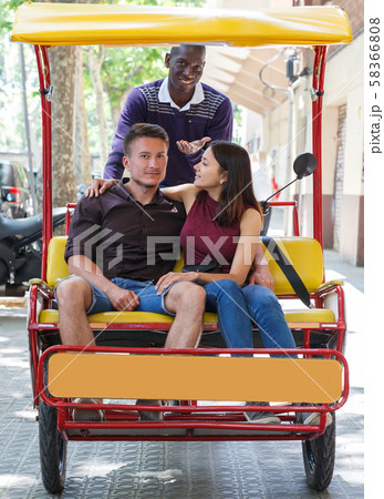 Happy girl with boyfriend traveling on rickshaw 58366808