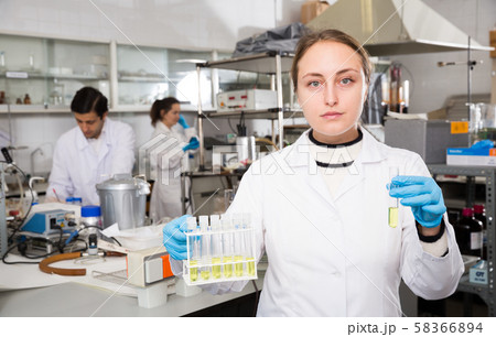 Female student examining chemical substances 58366894