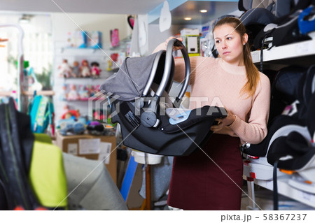 consumer with infant's car cradle 58367237
