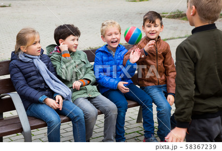 Kids playing with ball on bench 58367239