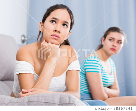 Quarreled girls apart on couch 58367241