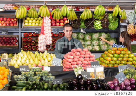 man seller in the department with vegetables man seller in the department with vegetables 58367329