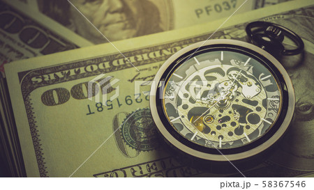 Pocket watch and dollar banknote stacking in darkness background. Concept of Time is money or Business. 58367546