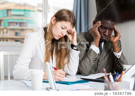 Upset coworkers working together Upset coworkers working together 58367786